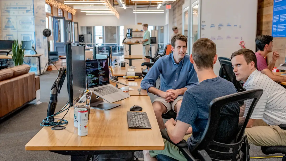 Team meeting in an open office to plan growth across industries